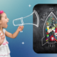 Confident child with a megaphone and back to school rocket drawing on a blackboard at School Beyond Limitations