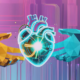 Human and AI hands holding a glowing heart, symbolising